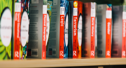 A bookcase showing a collection of books called 'the basics'